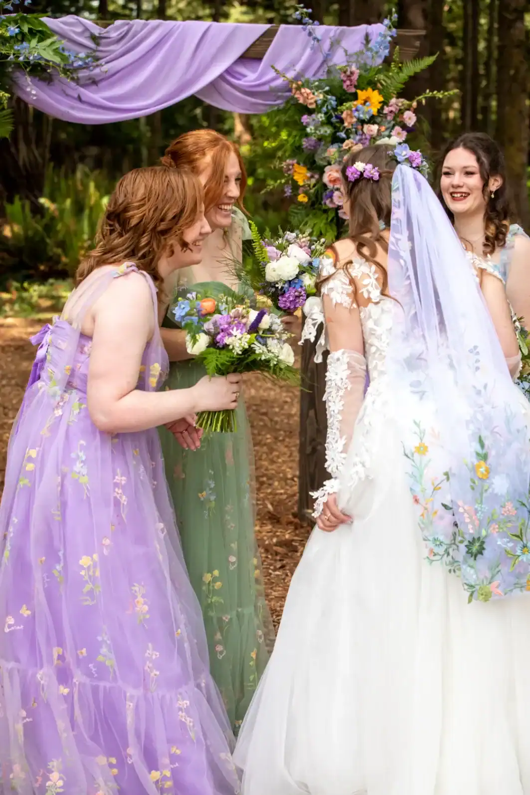 beth and bridal party in the grove